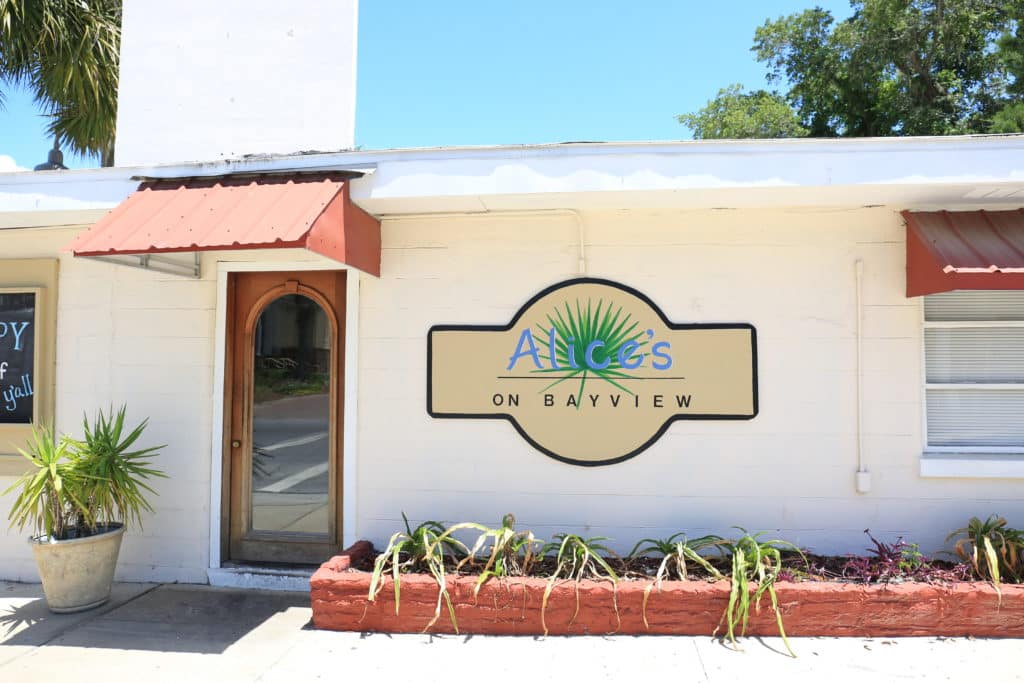Alice’s on Bayview, featuring a charming exterior with a welcoming entrance, stands out among Panama City's most scenic waterfront restaurants.