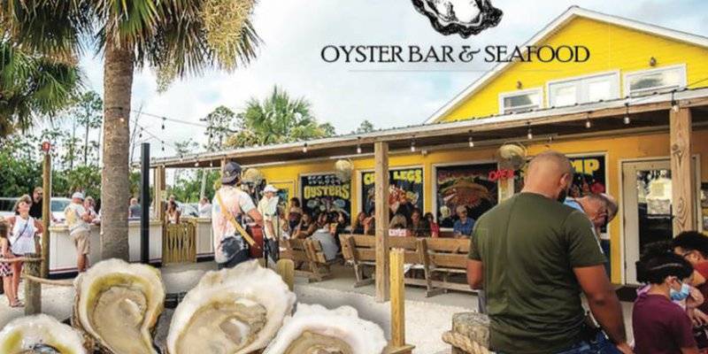 Hunt’s Oyster Bar & Seafood with outdoor seating and live music, showcasing its vibrant atmosphere, part of Panama City's most scenic waterfront restaurants.