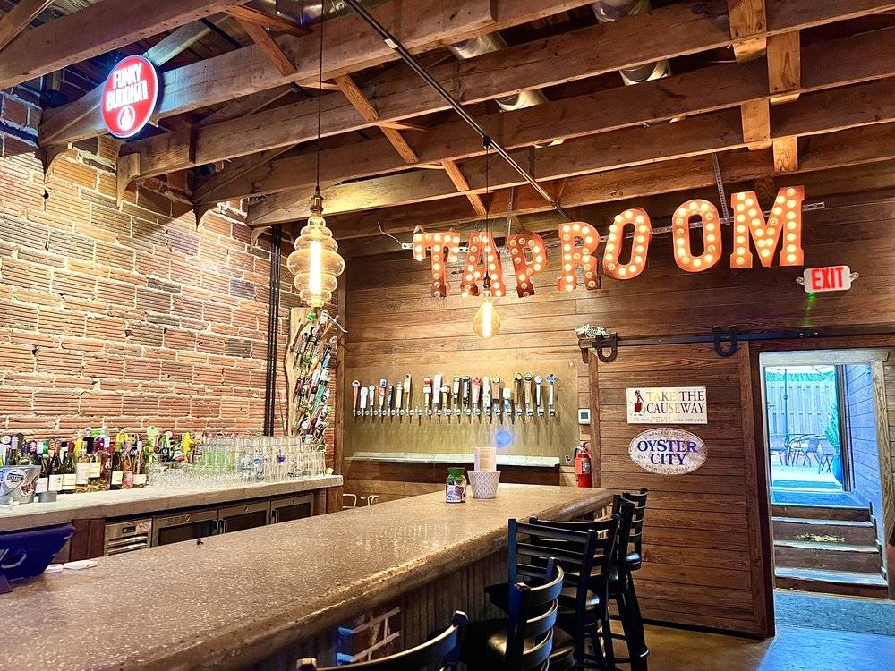 The Taproom at The Grocery Kitchen, with its inviting bar and rustic decor, stands out among Panama City's most scenic waterfront restaurants.