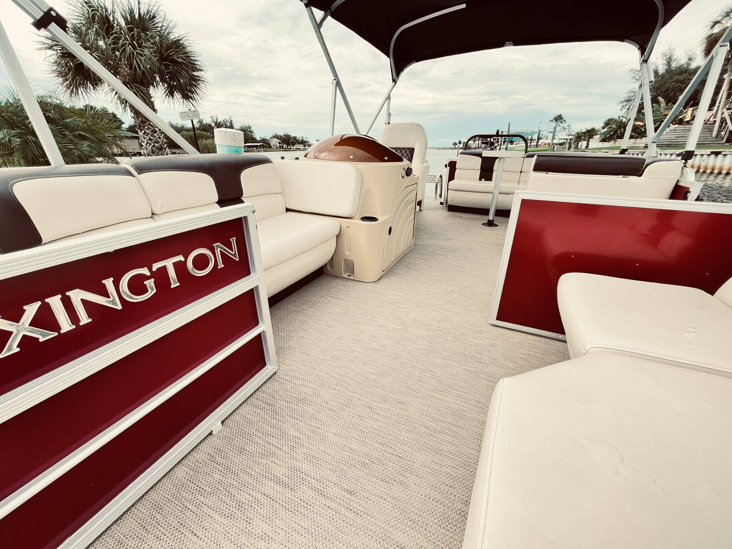 Interior view of a spacious pontoon boat with comfortable seating and open space, inviting you to be your own captain and enjoy the ride.
